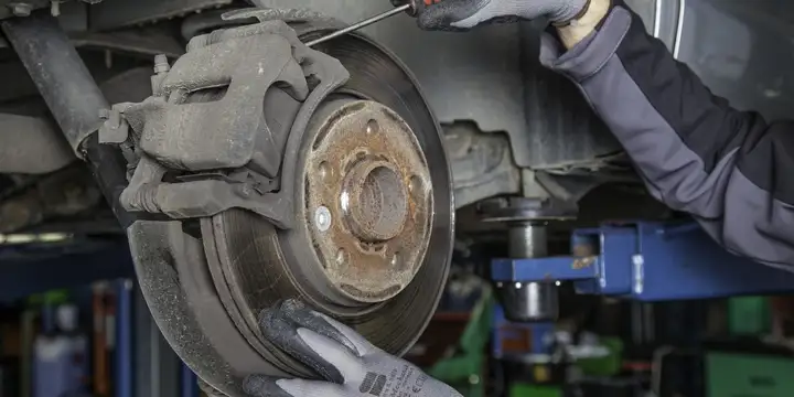 Illustration: brake caliper and rotor during a brake repair