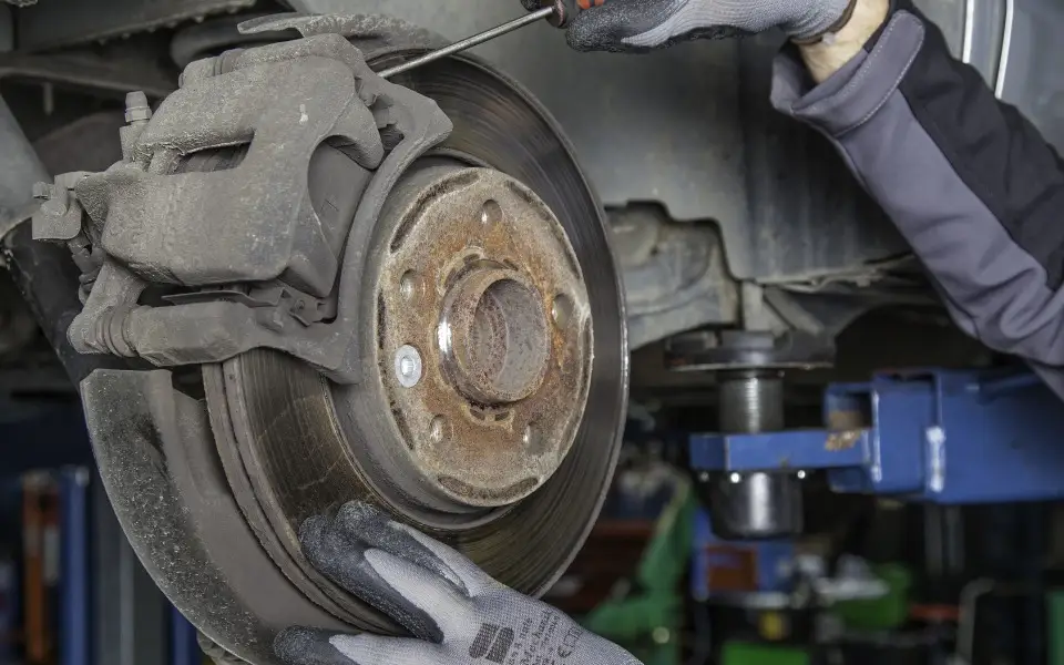 Illustration: brake caliper and rotor during a brake repair